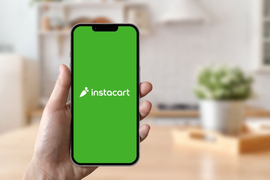 Hand holding a phone running Instacart app