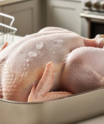 Frozen Butterball turkey breast in a shallow roasting pan on a kitchen counter, ready to bake without thawing.